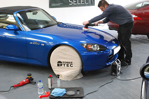 Polishing a blue car